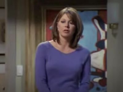 Jane Leeves is wearing a purple top.